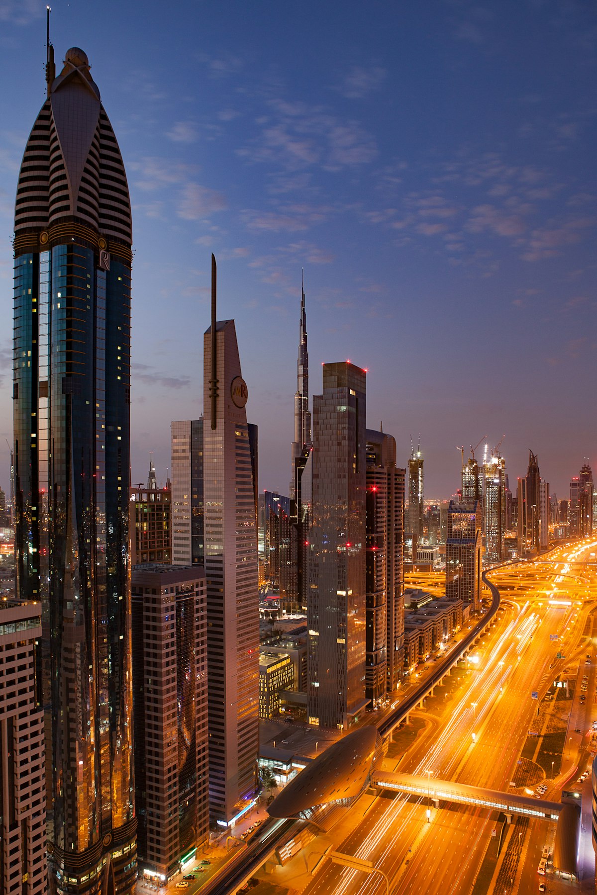 Dubai city skyline along Sheikh Zayed Road at dusk