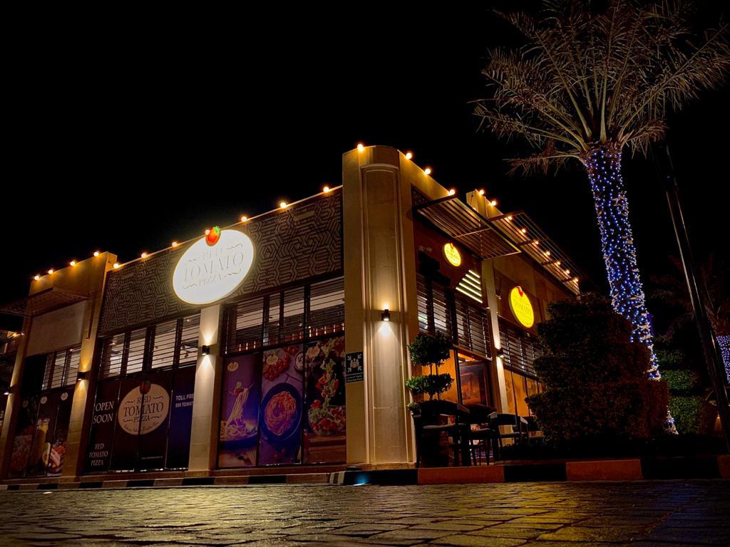 Red Tomato Pizza Sharjah branch storefront lit up at night